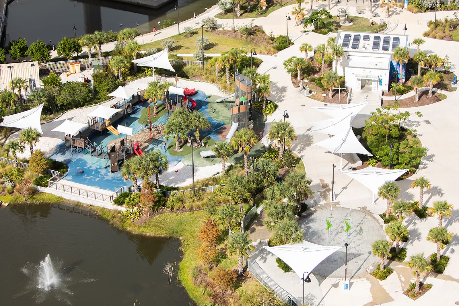Aerial view of Coachman Park in Downtown Clearwater with playground, palm trees, and waterfront amenities