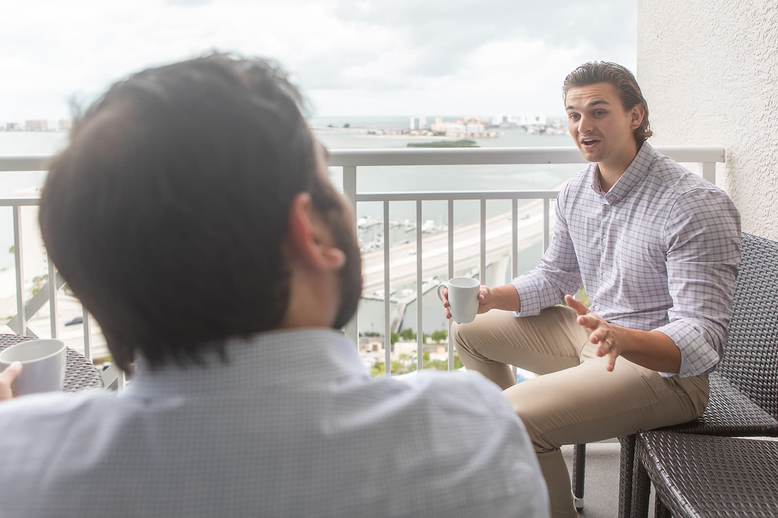 Sam Wilson discussing Clearwater's future on a balcony overlooking the waterfront