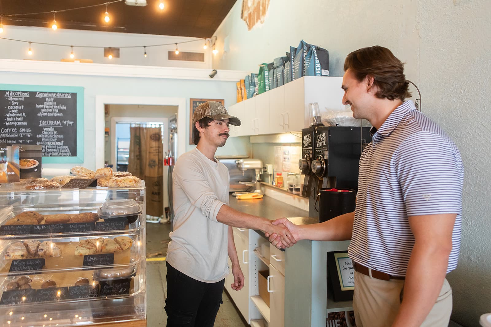 Sam Wilson greeting a local business owner at a Clearwater coffee shop