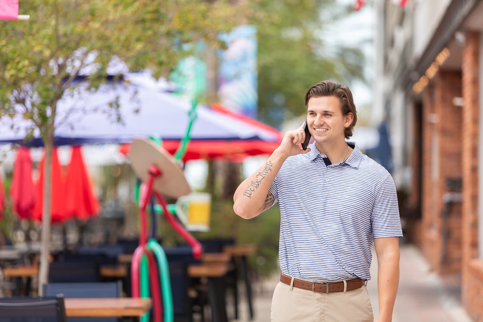 Sam Wilson talking on the phone while walking through downtown Clearwater